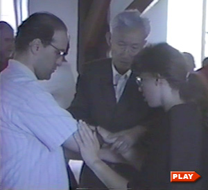 Dr. Tao adjusts push hands position of two students