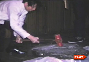 William Chen using a sledge hammer to break a rock on a student's stomach