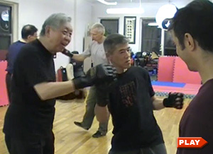 William Chen teaching the uppercut punch to Kan K.
