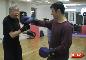 William Chen demonstrates uppercut to student