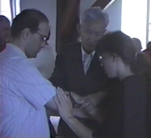 Dr. Tao adjusts push hands position of two students